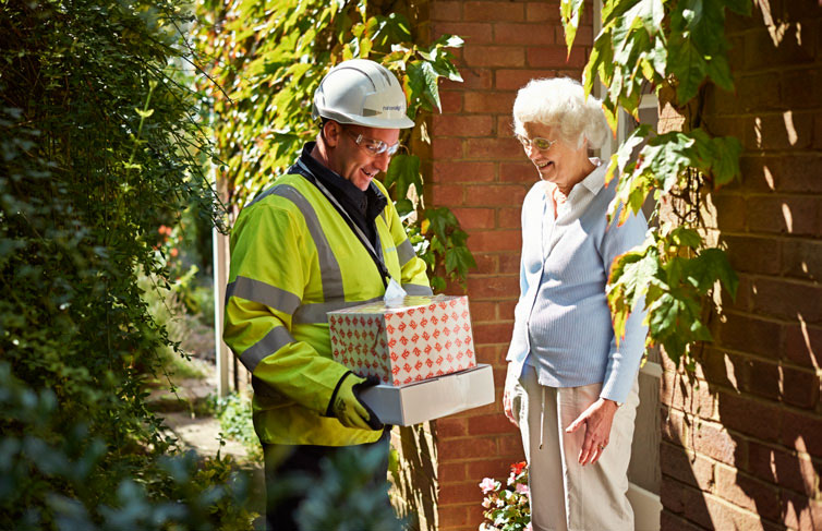 Engineer with gift alongside customer