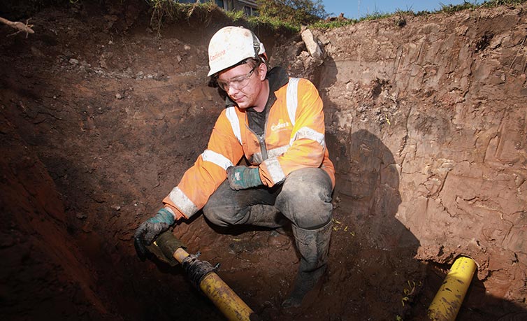 Cadent engineer near site checking gas pipes