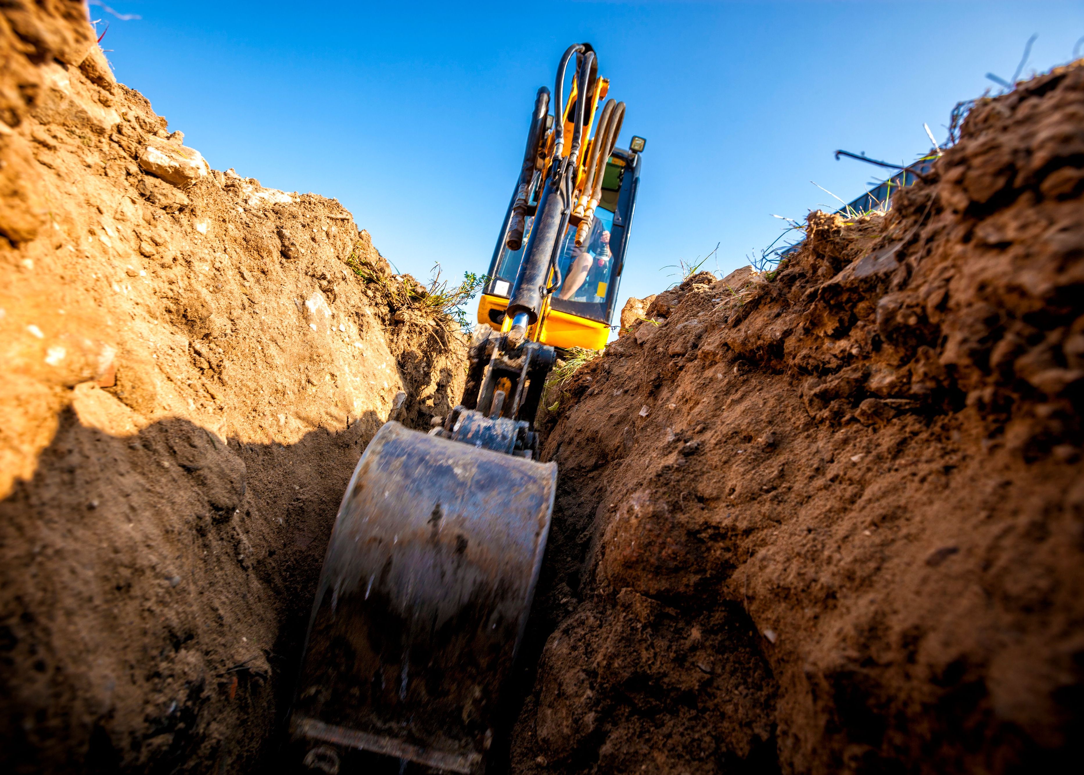 Mini Excavator. Excavator digs the foundation for the house. 