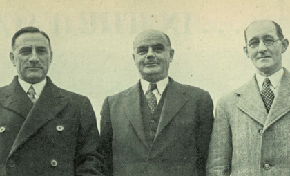 Three men in suits and ties stand side by side, looking at the camera. They appear serious but approachable, wearing early 20th-century attire.
