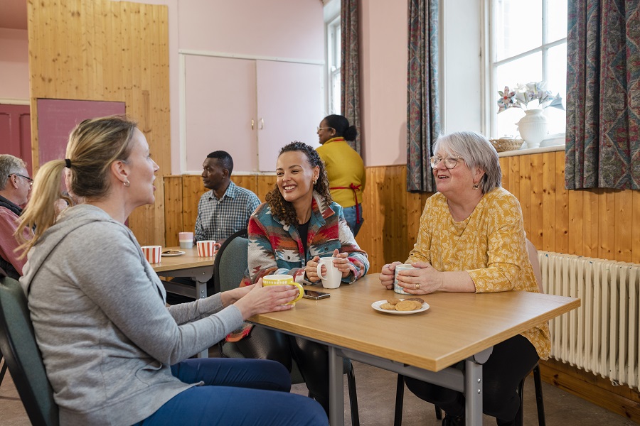 A group of ladies sat having a cup of tea and a chat