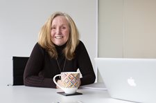 a woman sitting on chair and smiling